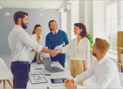 Business professionals shaking hands in a modern office, symbolizing collaboration and successful partnership